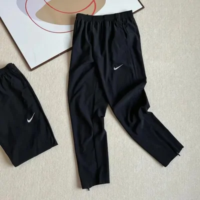 A pair of black joggers photographed on a hanger