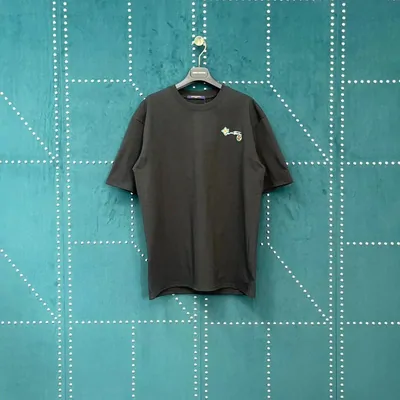 A dark tee with a small embroidered logo, on a hanger